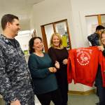 From the left, Petty Officer First Class Rob Stuart, Tiffany Wheeler-Thompson, Joanne Pelant and Carolyn Pence look at some of the clothes Stuart donated after running a drive with his squadron, VAQ-129. Stuart collected nearly 600 pieces of clothing for the Housing Support Center. Photo by Laura Guido/Whidbey News-Times