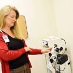 Kay Draper, clinic manager of the new WhidbeyHealth Womens Care clinic in Oak Harbor explains the colposcope, which is used to exam the cervix. All the equipment in the clinic is new and was paid for by the WhidbeyHealth Foundation. Photo by Laura Guido/Whidbey News-Times