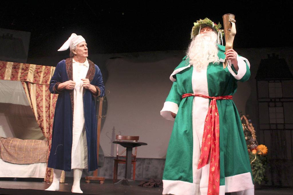 Ebenezer Scrooge (Benjamin Honeycutt) wonders about the Ghost of Christmas Present (Ron Wilhelm) during one scene in A Christmas Carol. Tickets are $10.
