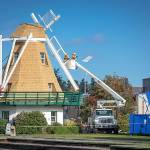 Photo by Pam Headridge                                Workers remove the paddles on the windmill in Oak Harbors Windjammer Park in October.