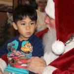 Arjay Andal looks a little perplexed as Santa Claus asks a few questions during Saturdays Meet Santa event for families following the annual Oak Harbor tree lighting ceremony. Santa has more meet and greets through Dec. 23. Photos by Patricia Guthrie/Whidbey News-Times