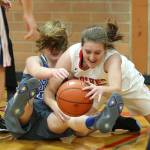 Coupevilles Mikayla Elfrank dives over Mount Vernon Christians Josie Droog to corral a loose ball. (Photo by John Fisken)