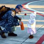 A sailor greets his baby after returning Tuesday from a six-month deployment with Electronic Attack Squadron 142. Photo by Laura Guido/Whidbey News-Times