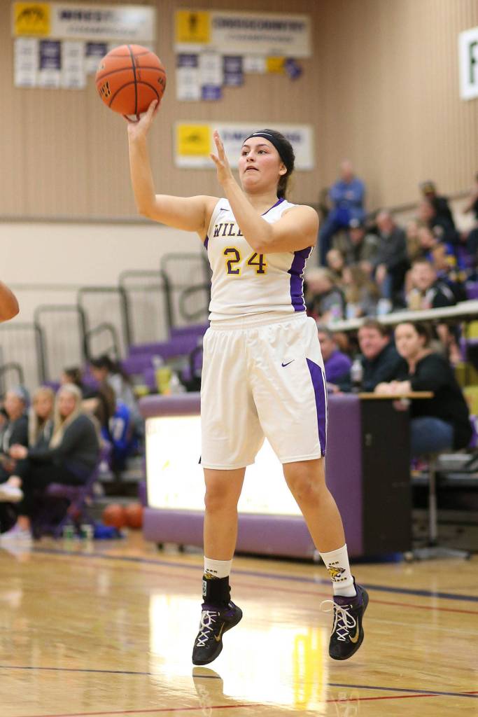 Jordan Wood-Pina tosses a three-point attempt for Oak Harbor.(Photo by John Fisken)