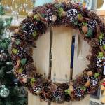This wreath is packed with pinecones with other natural touches. Wreaths for all seasons are made by A Knot in Thyme artist and employee Tressa Green, including ones with seashells and dried flowers. Wendy Rawls challenged her to try a new design using all things pines. She said, Oh I know you can do it, Green said. And it came out really well.