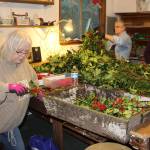 Its a holly jolly job for this wreath-making crew, many whove returned year after year to work with Rob Henderson. Inside the elf workshop of Henderson Holly Farm are Carolyn Anderson (left), Linda Carlsness (center) and Susan Gwost. I call it spirit work, said Gwost, going on her 15th year making magic with holly and evergreen.