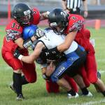 Coupeville tacklers smother a South Whidbey ball carrier in a non-league game in 2016. The Wolves could be joining their island rivals in a new confernce next year. (Photo by John Fisken)