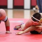 Chris Brooks works for a fall against Meadowdales Thaddeus Ganzales. (Photo by John Fisken)