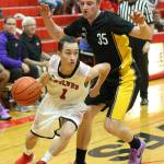 Jered Brown drives by Sequims Riley Cowan in Fridays game. (Photo by John Fisken)