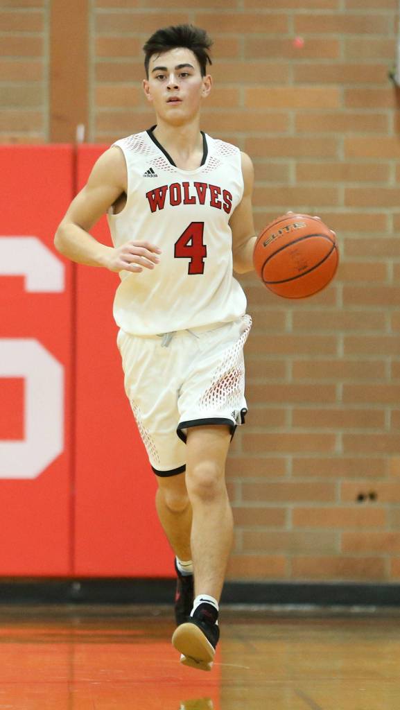Point guard Hunter Smith brings the ball up the floor Friday. Smith led Coupeville in scoring in both games this weekend.(Photo by John Fisken)