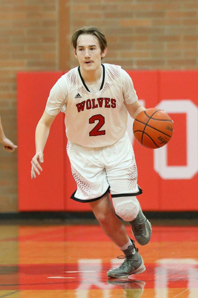 Ethan Spark looks for a hole in the Sequim defense.(Photo by John Fisken)