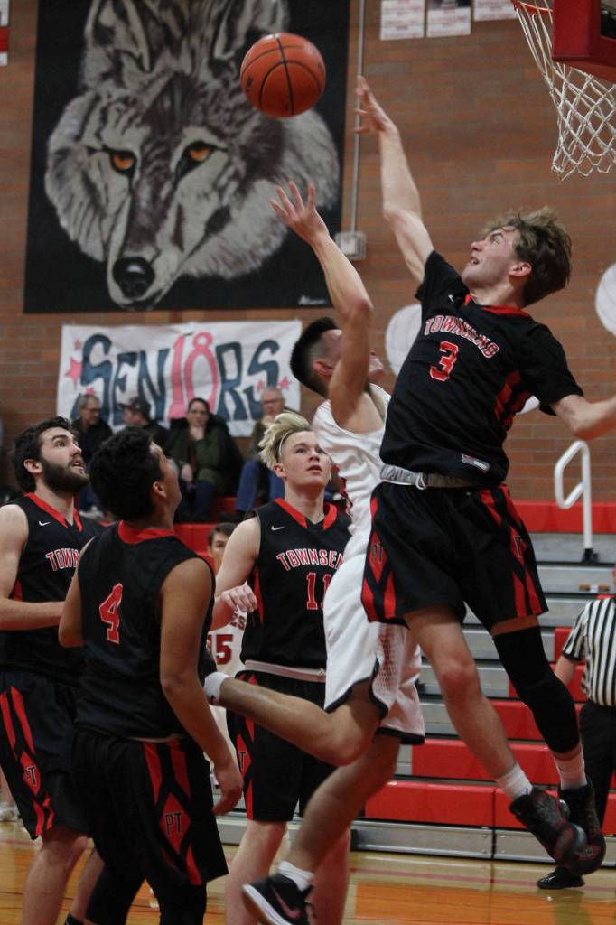 Hunter Smith (white jersey) attracts a crowd of Port Townsend defenders on the way to scoring over the Redhawks Jaden Watkins.(Photo by Jim Waller/Whidbey News-Times)