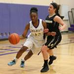 Delija Cammon, left, drives by Lynnwoods Emily Whybark. (Photo by John Fisken)