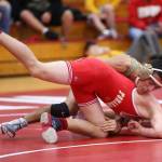Caleb Fitzgerald, top, works to keep control of M-Ps Austin Davis.(Photo by John Fisken)