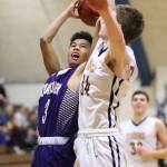 Terrell Crumpton attacks the defense of B-Es Brian McGovern.(Photo by John Fisken)