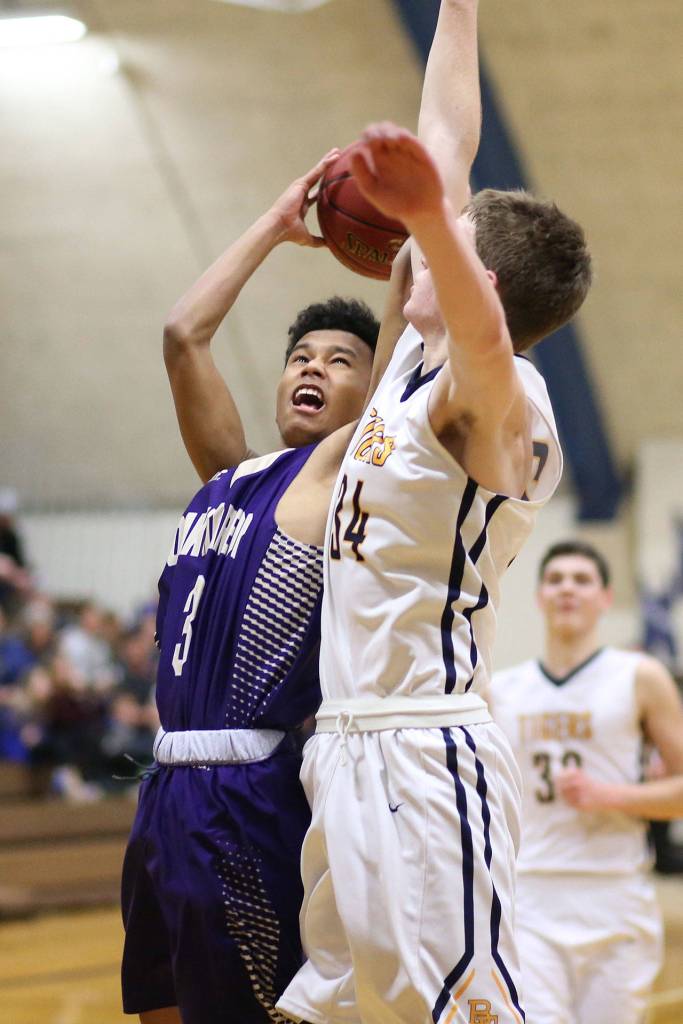 Terrell Crumpton attacks the defense of B-Es Brian McGovern.(Photo by John Fisken)