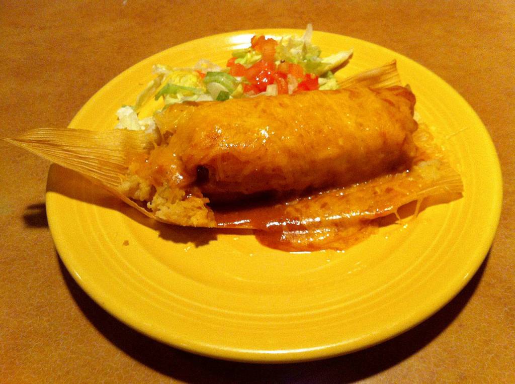 Tamale with red chile sauce prepared by El Cazador. It makes thousands of tamales during the holidays, sold by the dozen steamed or frozen. Photo provided