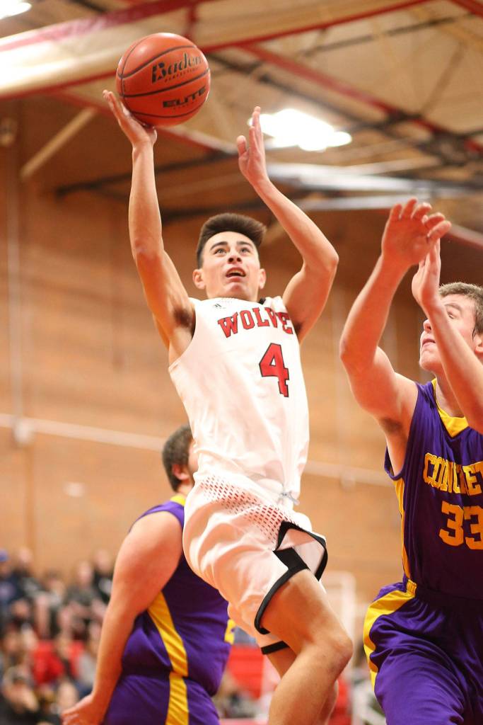 Smith times two. Hunter Smith (above) and sibling Scout (below) take the ball to the rim for the Wolves.(Photos by John Fisken)