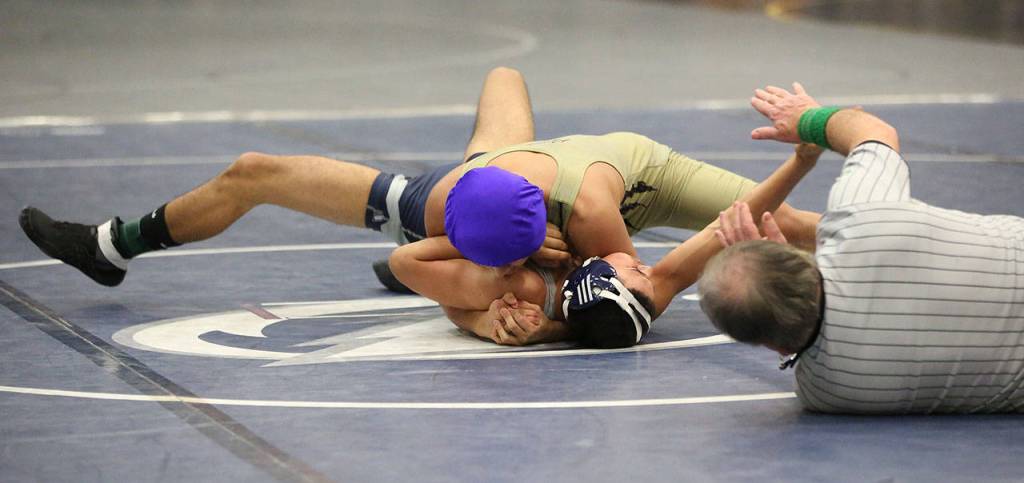 Oak Harbors Giovanni Ribay has his Squalicum opponent in trouble.(Photo by John Fisken)