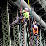 Climbers working for the state Department of Transportation rappel off the side of DeceptionPass Bridge in May during a regular inspection. Whidbey News-Times file photo.