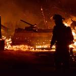 A firefighter walks near the remains of the Smith Barn in Ebeys Prairie. In March the historic structureburned to the ground. Whidbey News-Times file photo.