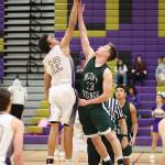 Oak Harbors Ozell Jackson (12) wins the opening tip over Mount Vernons Michael Baldwin.(Photo by John Fisken)