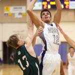 Ozell Jackson shoots over the defense of Mount Vernons Dylan Cyr.(Photo by John Fisken)