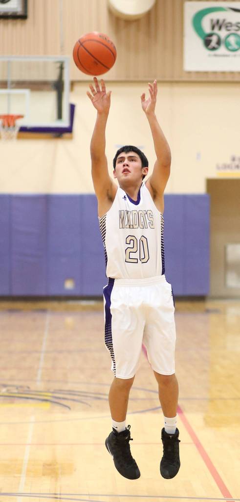 Weston Whitefoot fires a jump shot for the Wildcats.(Photo by John Fisken)