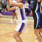 Oak Harbors Mikhaela Cortez, left, looks to shoot over the defense of Kolby Heggenes. (Photo by John Fisken)