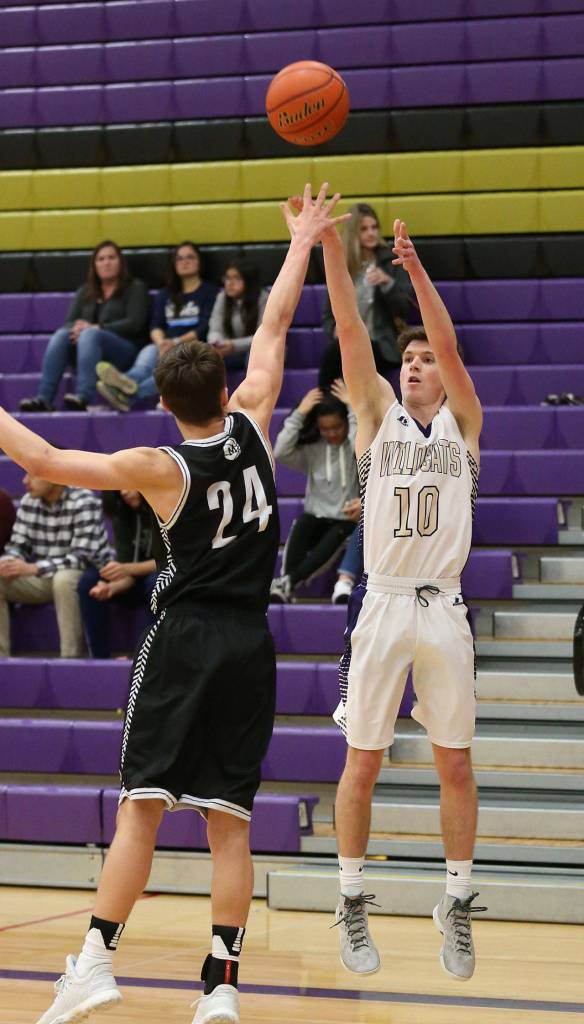 Gabe Salinger launches a shot over Meridians TJ Dykstra.(Photo by John Fisken)