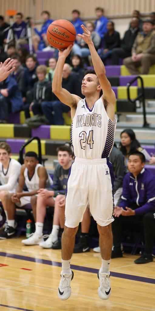 Haven Brown launches a three-point shot for Oak Harbor. (Photo by John Fisken)