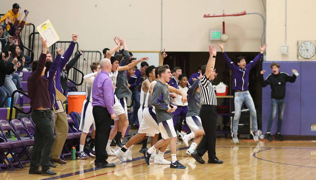 The photo above and the others below follow Oak Harbors celebration after Dorian Hardin hit a buzzer-beater to earn the Wildcats the win over Shorewood Tuesday. Hardin is smoothered by his teammates and fans in the final photograph.(Photos by John Fisken)