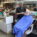 Wanting a little off the top customer Bo Chernikoff sits down for a trim at Midway Barber Shop in Oak Harbor. Owner Dave Cleary recently returned after undergoing brain surgery for a cyst that affected his vision. Photo by Patricia Guthrie/Whidbey News-Times