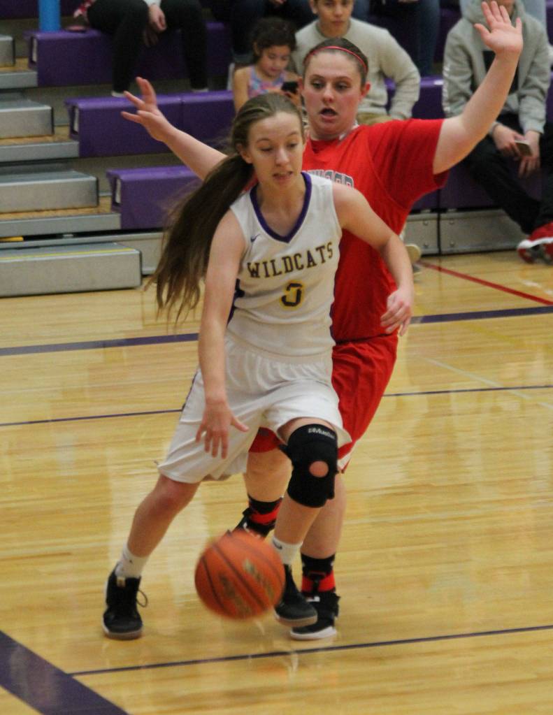 Oak Harbors Miranda Wilson slips by Allie Jones on the baseline.(Photo by Jim Waller/Whidbey News-Times)