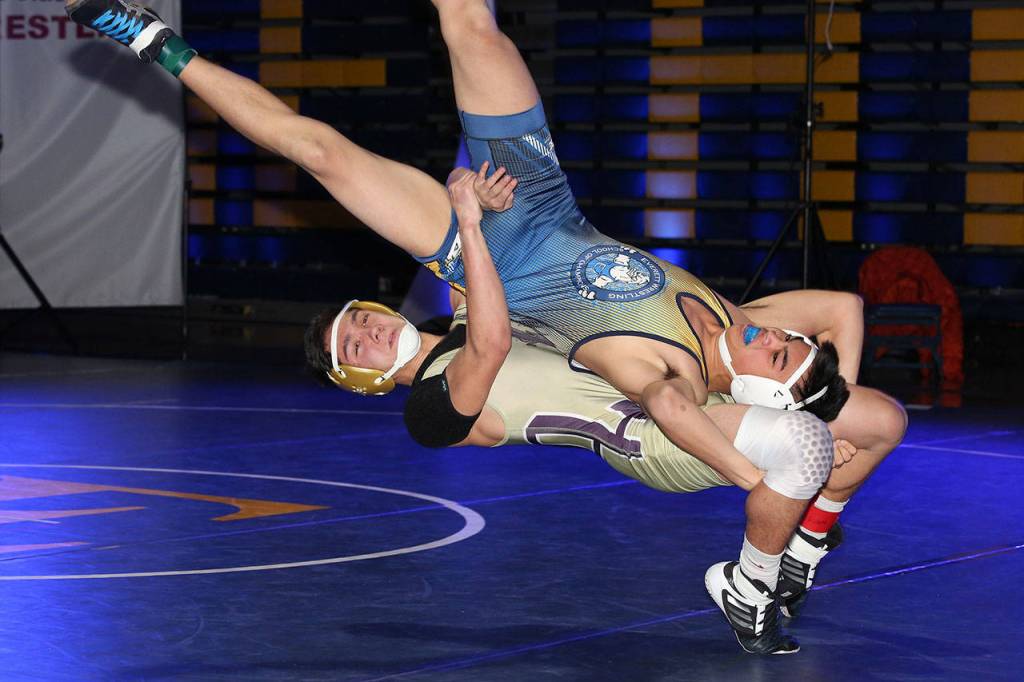 Oak Harbors Shingo Johnston, bottom, takes his Everett opponent for a ride.(Photo by John Fisken)
