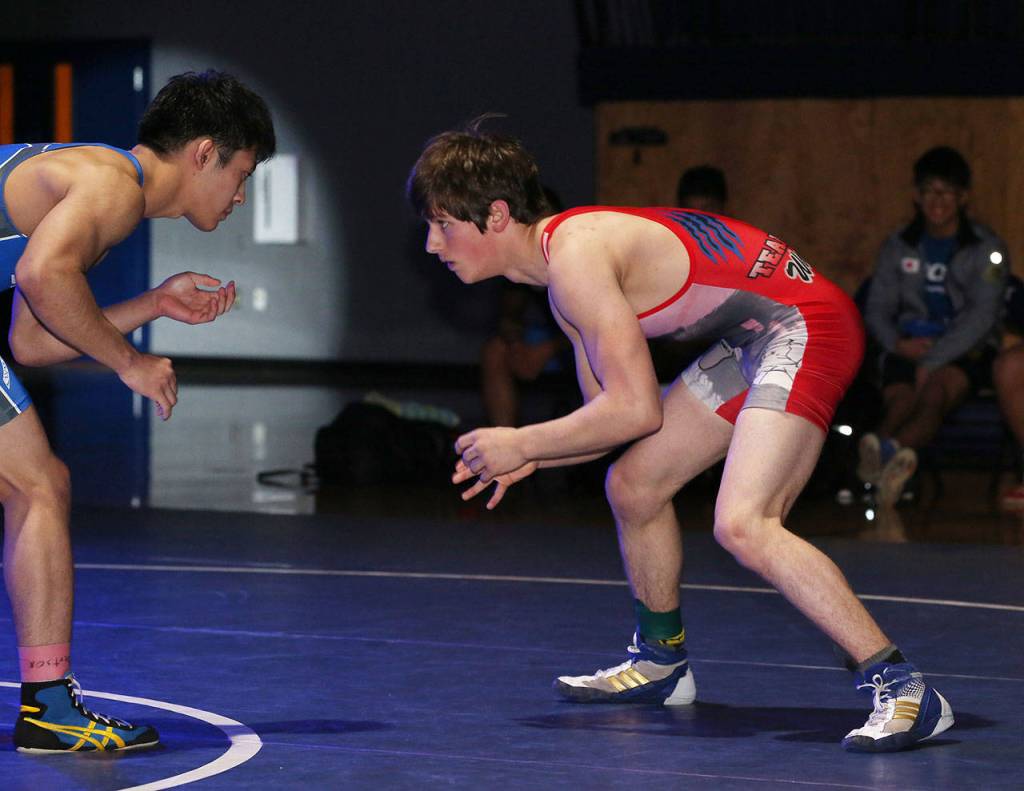 Blake McBride, right, takes part in the cultural exchange match Friday in Everett.(Photo by John Fisken)