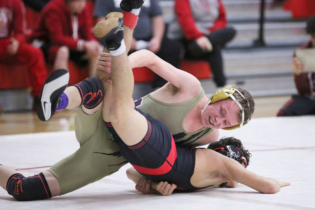 Blake Servatius, top, works on turning North Salems Daniel Labra at the Panther Classic. Servatius pinned Labra in the second round of the match for third place.(Photo by John Fisken)