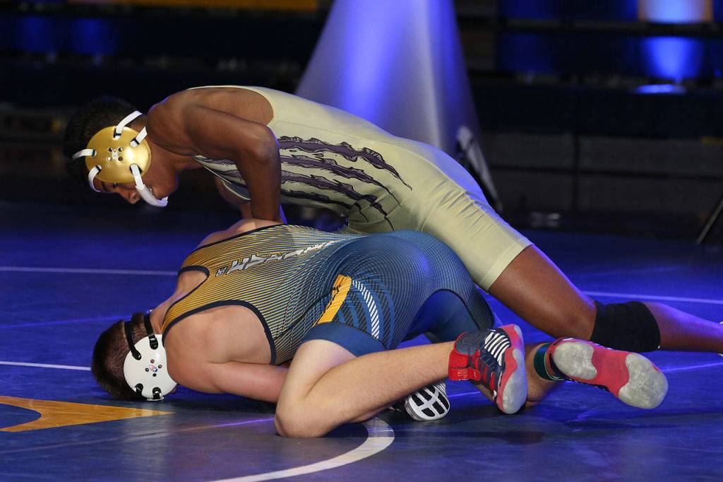 Tayvion Shaw, top, scraps with his Everett counterpart in Fridays match.(Photo by John Fisken)