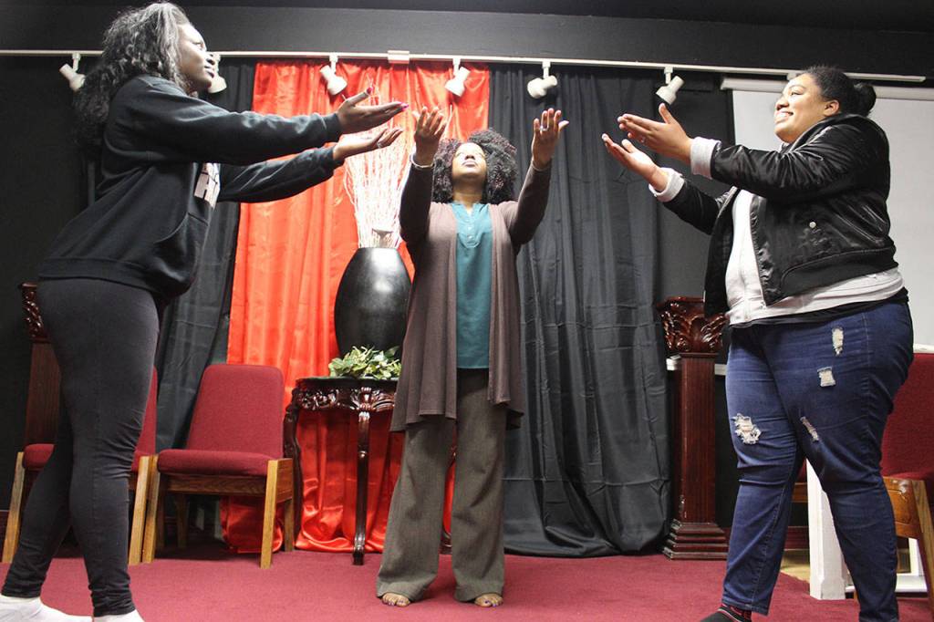 Praise Dancers of Mission Ministries practice for the annual Oak Harbor Martin Luther King Day Jr. church service. Wismine Davilar (left) Jendayi Stafford (center) and Nicole Rice are part of an 8-person group. Photo by Patricia Guthrie/Whidbey News-Times