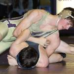Oak Harbors Blake McBride, top, tries to turn Gavin Howell.(Photo by John Fisken)