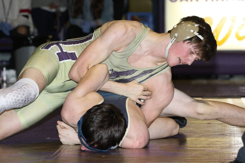 Oak Harbors Blake McBride, top, tries to turn Gavin Howell.(Photo by John Fisken)