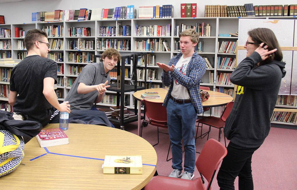 Gathering during their usual study period in the library to work on inventory and organizing books are Coupeville High School seniors, left to right, Logan Johnston, Kenny Johnson, Jacob T. Smith and Raechel Kundert. Photo by Patricia Guthrie/Whidbey News-Times
