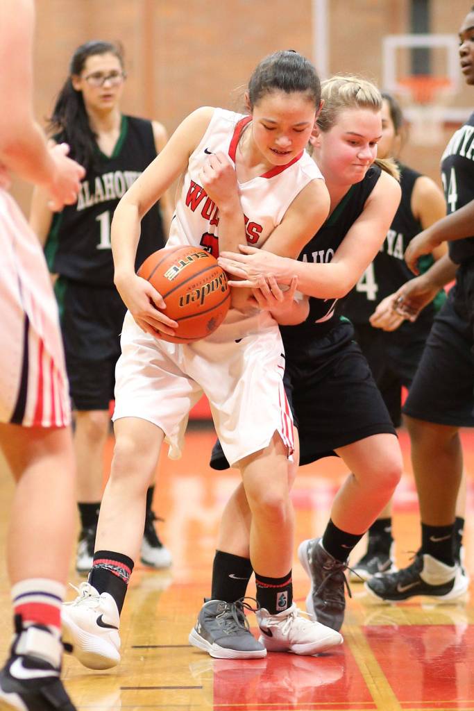 Coupevilles Scout Smith wrestles the ball away from Karli Eberhart.(Photo by John Fisken)