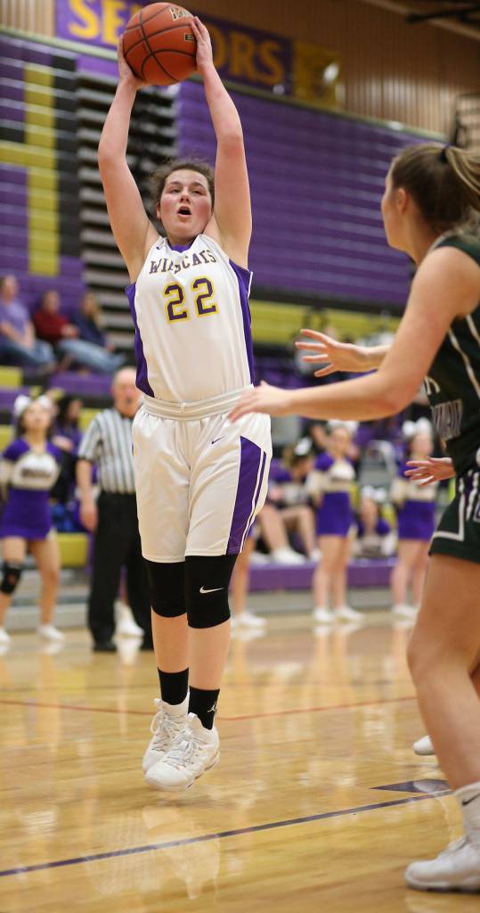 Mia Littlejohn pulls down a rebound for Oak Harbor.(Photo by John Fisken)