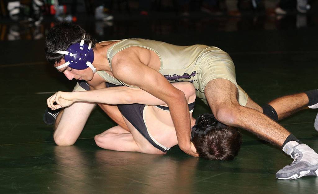 Oak Harbors Caleb Fitzgerald, top, turns Tanner Condon on the way to a second period fall.(Photo by John Fisken)
