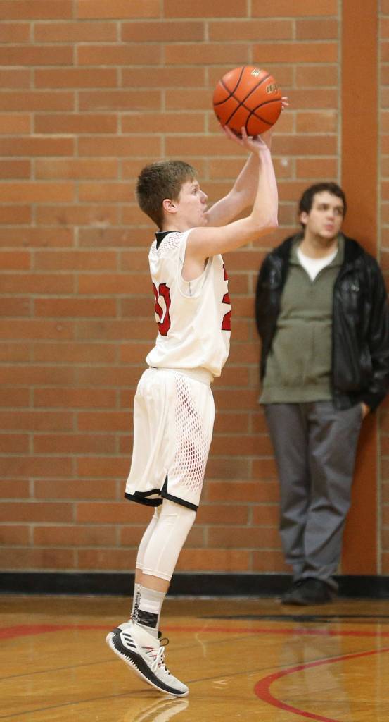Mason Grove launches one of his four successful three-point shots against Chimacum.(Photo by John Fisken)