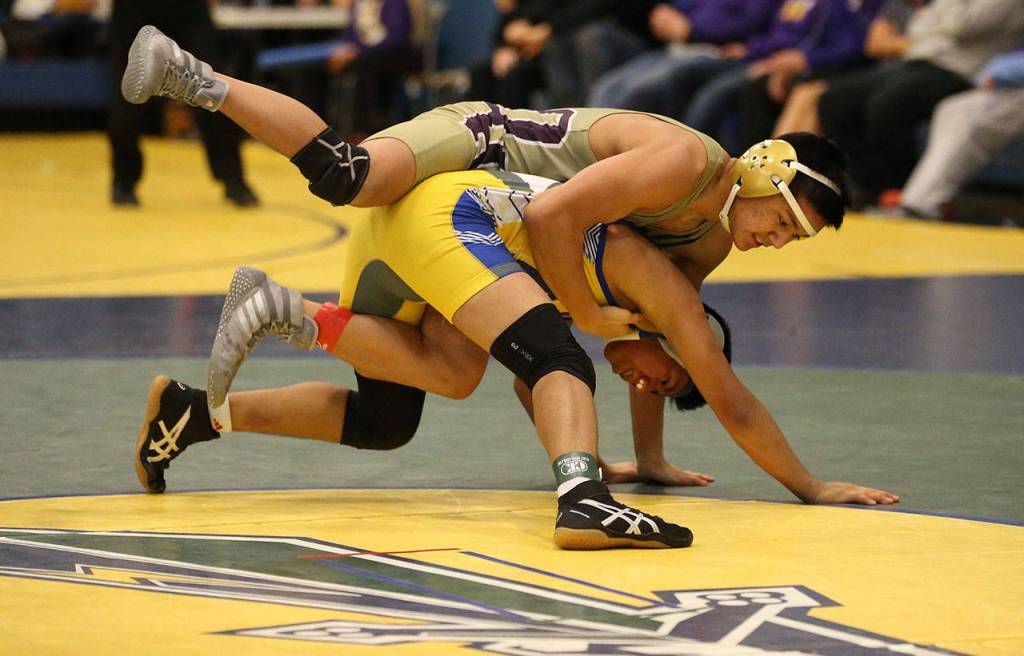 Oak Harbors Giovanni Ribay, top, works to take his Hazen opponent down to the mat.(Photo by John Fisken)
