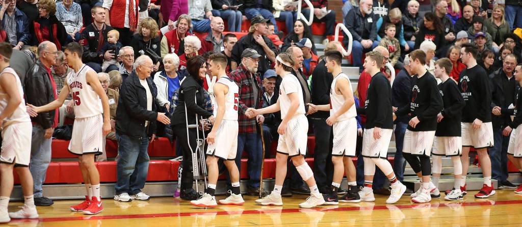 The current Coupeville players shake hands with the past athletes last Friday.(Photo by John Fisken)