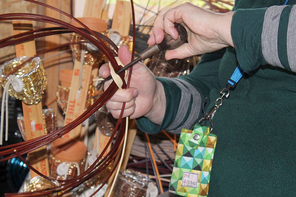 Making baskets doesnt entail many tools for Reggie Kastler. Here, she uses an awl. Scissors, small clippers and tough hands are also important.