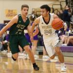 Oak Harbors Haven Brown (24) attacks the baseline against Marysville Getchells Dylan Rice. (Photo by John Fisken)